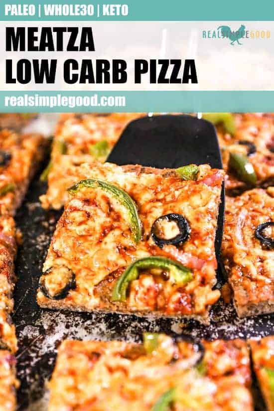 Cut up Meatza in sheet pan with spatula lifting a piece out close up image. Text on top for pinterest