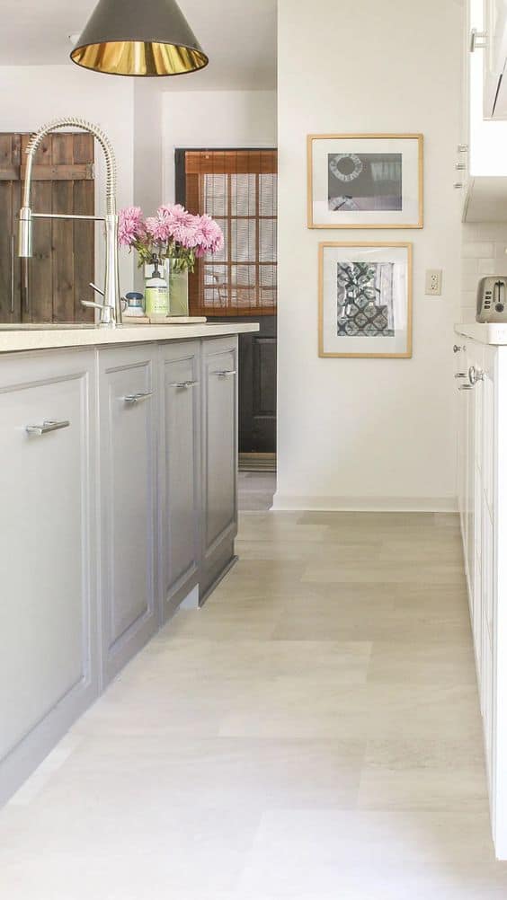 plain vinyl floor tiles in a kitchen with grey cabinets, heavy pendant light and white walls