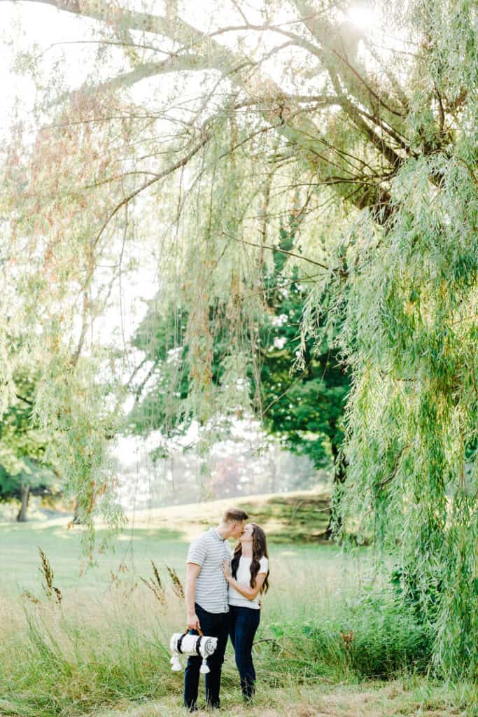 engagement session couple kissing under the weeping willow