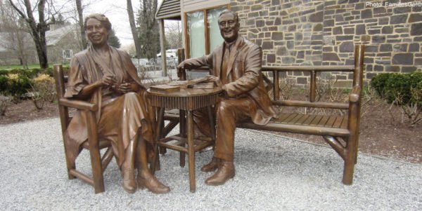A jovial franklin and eleanor roosevelt (statue) welcome visitors to their dutchess county estate, hyde park