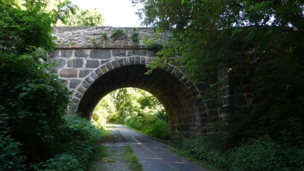 A stone bridge overpass on a more rural stretch of the washingtong and old dominion trail.