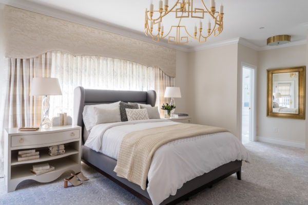 traditional yet cozy bedroom with white sheets and antique golden accessories