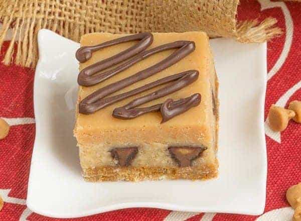 Peanut Butter Cheesecake Bars | Incredibly rich and filled with mini Reese's!