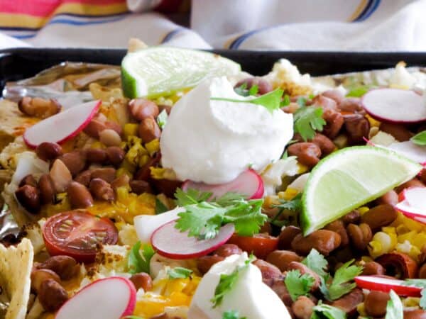 Healthy, low-carb, super easy loaded cauliflower nachos recipe! Use cauliflower as a meat substitute on these simple vegetarian nachos; it's so good, I even surprised myself!