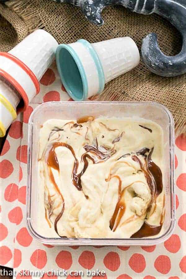Vanilla Caramel Swirl Ice Cream - a rich, dreamy ice cream with ribbons of caramel Vanilla Caramel Swirl Ice Cream in a freezer container