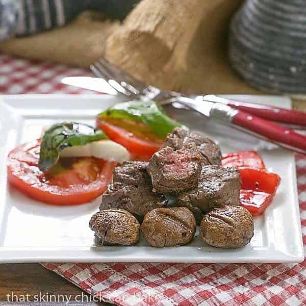 Tender Grilled Beef Steak Kabobs with a simple, flavor packed marinade Tender Beef Steak Kabobs on a white plate