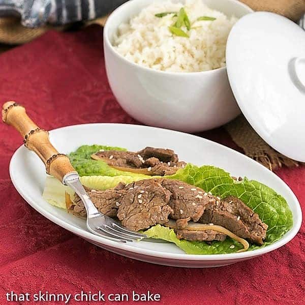 Beef Bulgogi is a quick, stir-fried Korean dish that is full of marvelous flavors including garlic and fresh ginger. A little spicy, a little sweet, you will love this easy Asian dinner recipe. White platter of Easy Korean Beef Stir Fry