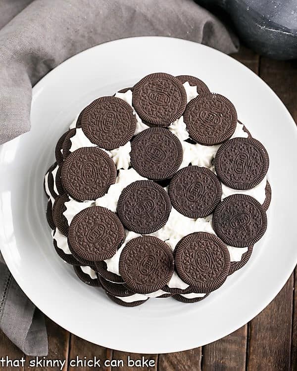Oreo Icebox Cake - Minimal ingredients and effort to make this marvelous no-bake dessert Overhead view of Oreo Icebox Cake on a white plate with a gray napkin