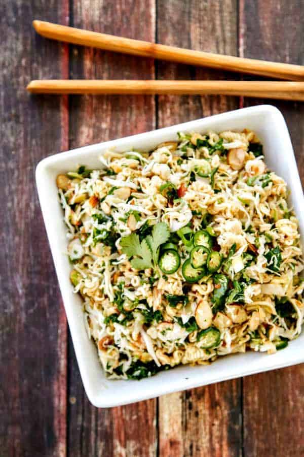 Asian Ramen Noodle Salad Asian Ramen Salad but made better with a homemade sesame dressing, kale for extra healthy goodness and a little serrano pepper to spice things up!
