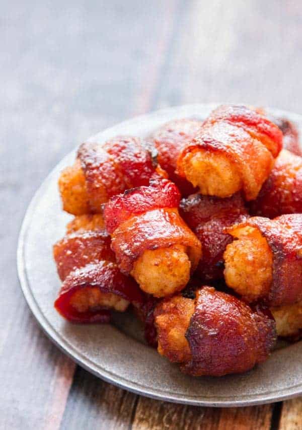 Bacon Wrapped Tater Tots with a Sticky-Sweet Spicy Glaze Spicy-Sweet Bacon Wrapped Tater Tots - just four ingredients and SO ADDICTIVE!!