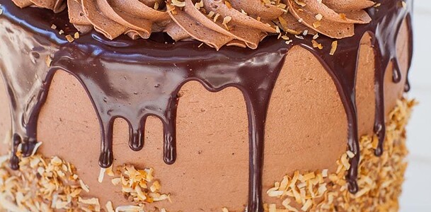 german chocolate cake with chocolate ganache and toasted coconut flakes