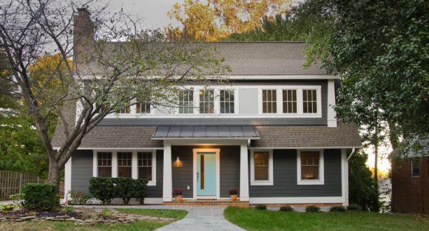 a craftsman exterior with dark grey color, white trim, and soft blue door