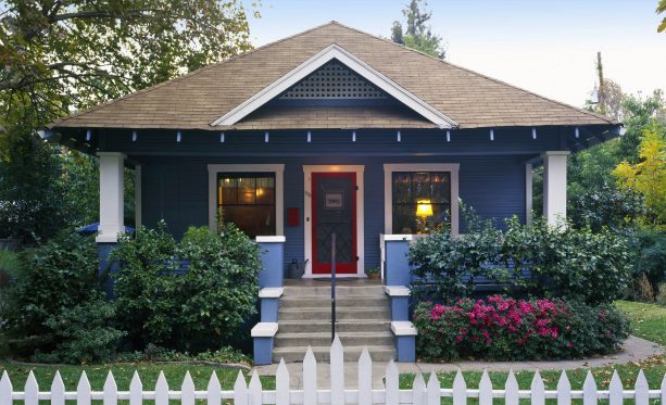 a blue house with a red door and red mailbox