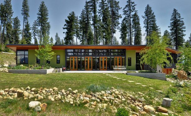 a modern mountain home with green paint that is similar with the grass floor