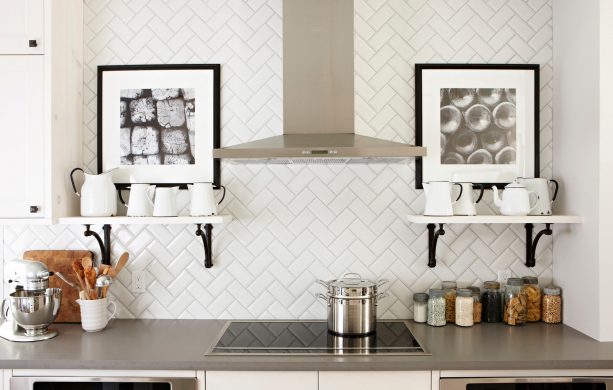 Herringbone style beveled white subway tile with gray grout detail
