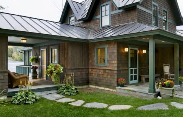 a rustic dark wood house with brown roof