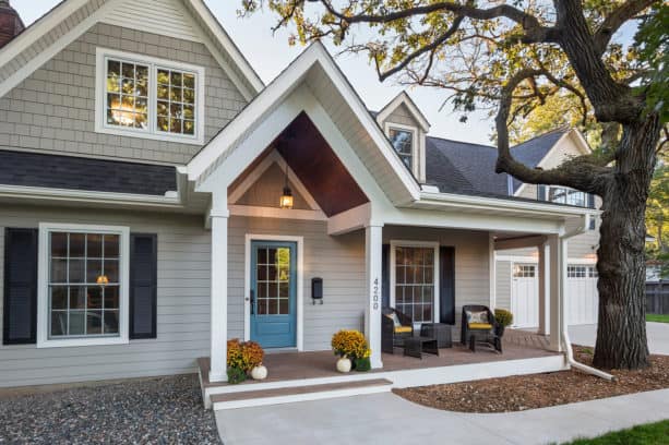 a traditional grey exterior with white trim and blue French door
