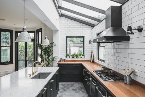 white subway tile wall and dark gray grout in an industrial open kitchen design