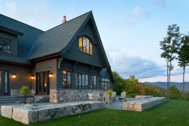 a gorgeous dark brown house looks like it belongs to the mountain area