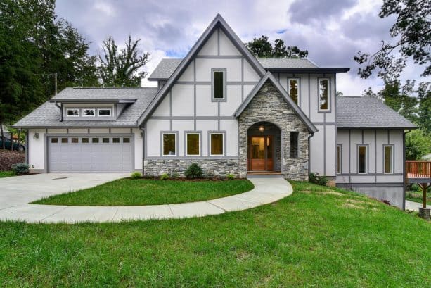 an off-white stucco exterior with grey trim