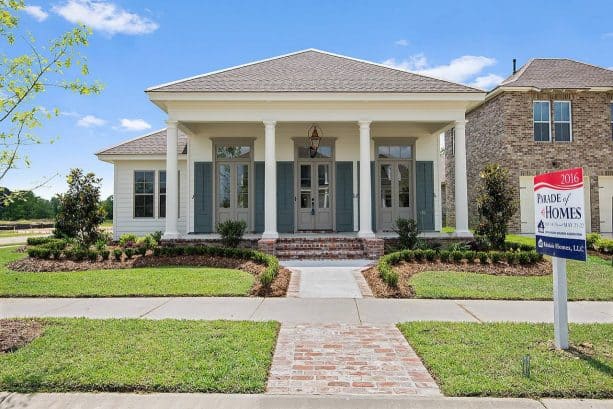 coordinating grey windowed-doors and trim in a traditional white home exterior design