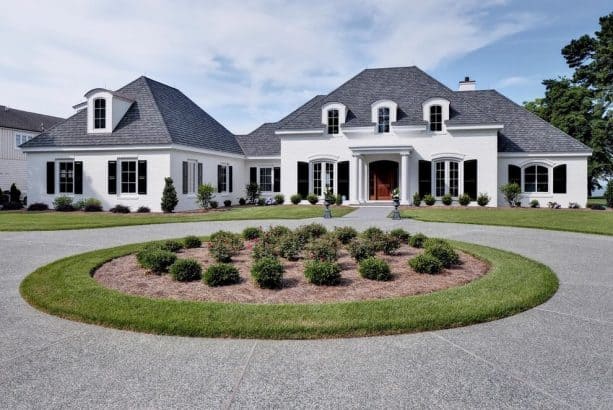 non-rectangular black shutters decorating a white house exterior