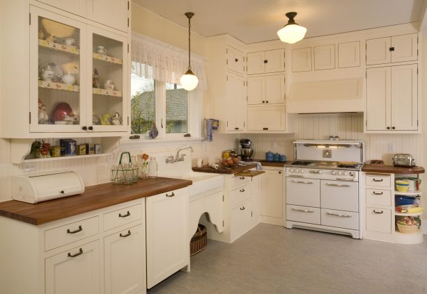 shabby chic kitchen with antique white cabinets and wood countertops