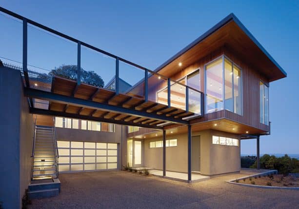 an attached carport with roof functioned as a deck with rails