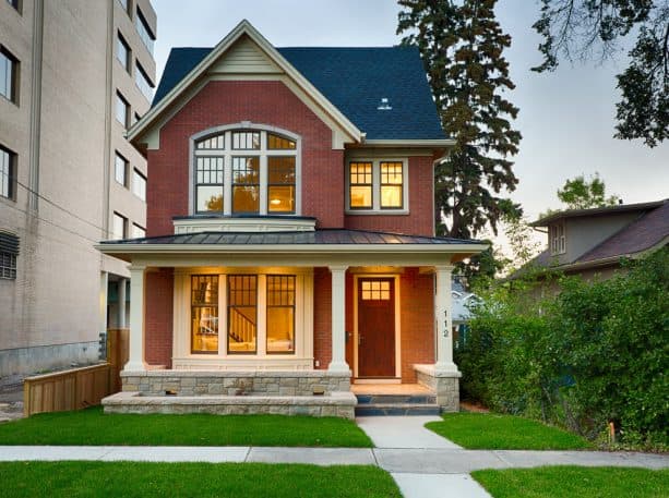 a whitewashed brick house with white metal roof