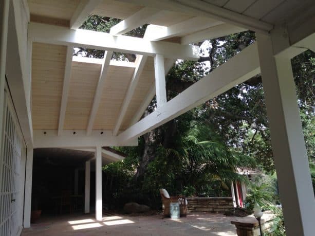 a solid patio cover with white tongue and groove roof deck