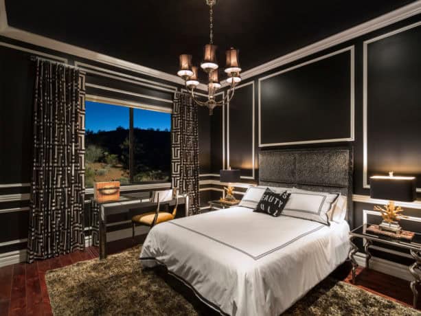 a contemporary bedroom with black, white, and gold color theme