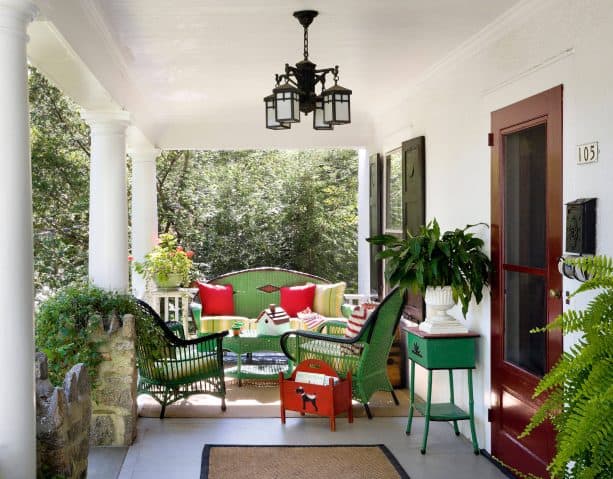 black shutters and colorful decor in a white home exterior