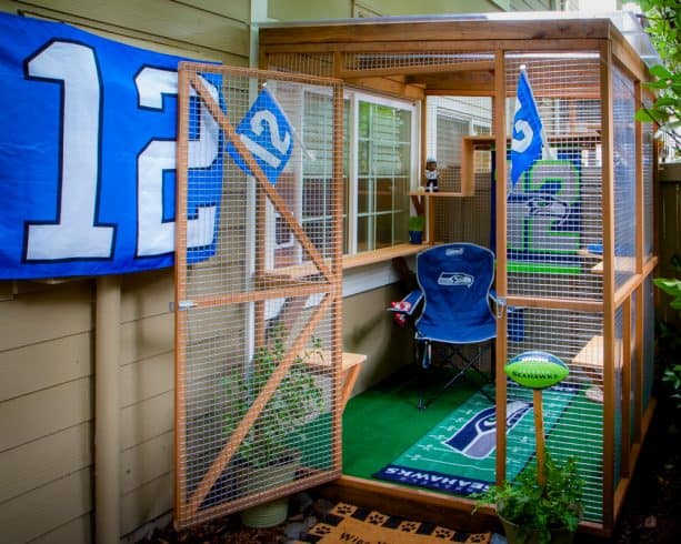 a cat enclosure with a Seattle Seahawks American football theme and a window door insert