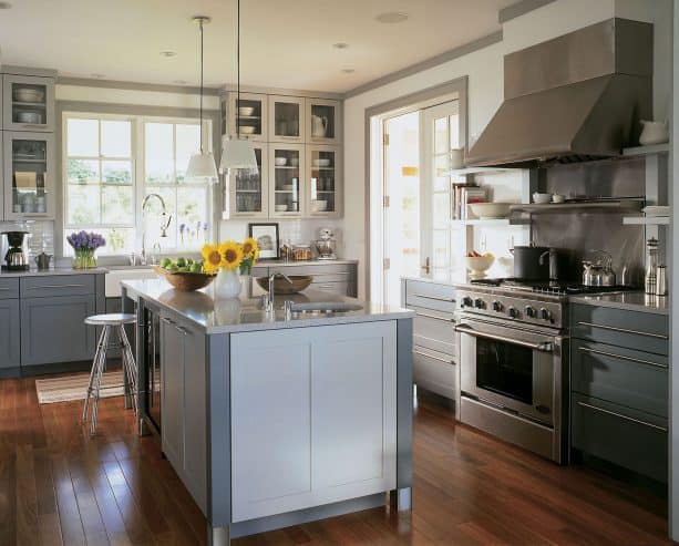 a contemporary kitchen interior with white walls, grey trim, white doors, and white windows