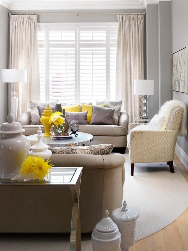 grey and yellow living room with yellow chrysanthemums in clear glass vase