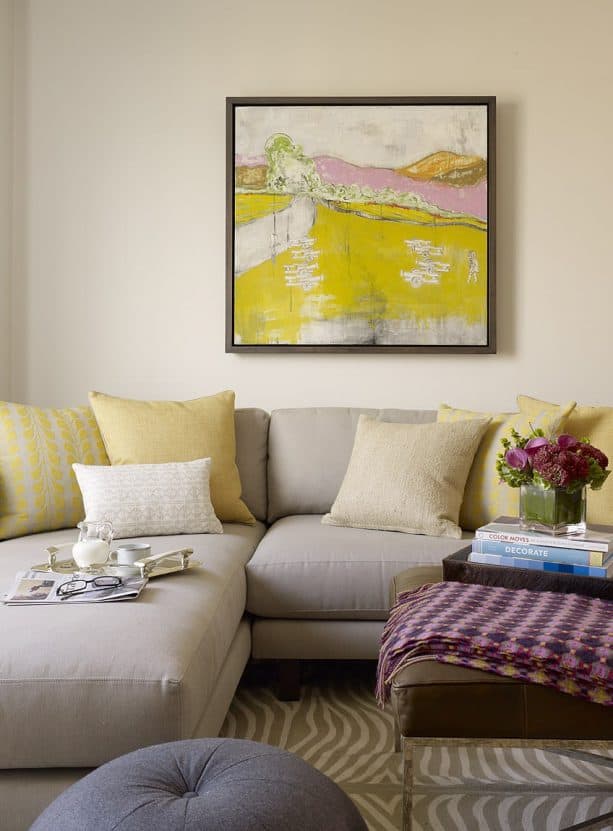 greige sectional sofa with mixed-pattern mustard cushions