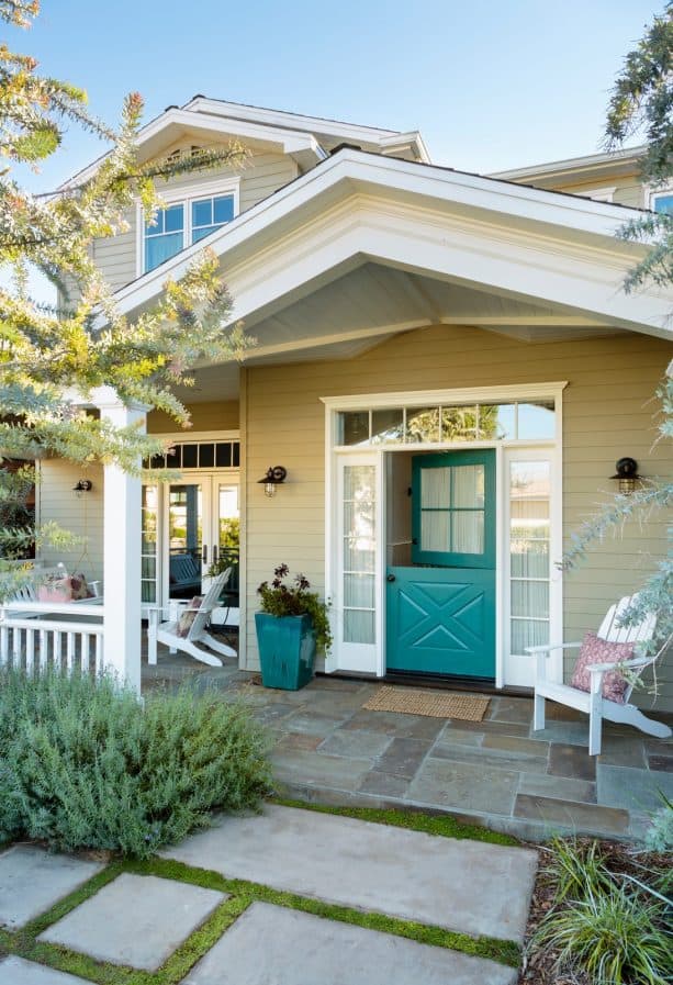 a greenish blue Dutch entry door with gathered sheer curtain