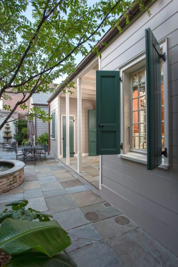 a tan wood siding with greyish green shutters