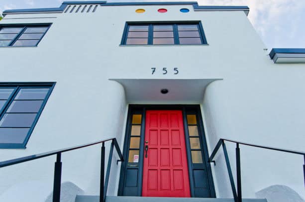 a bright red front door as a match for the black trim of a white house