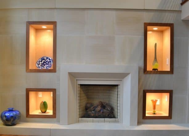 after makeover floor to ceiling tiles fireplace with built-in shelves with dramatic lighting, modern mantel and tiled raised hearth