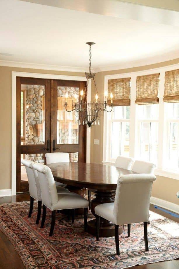 traditional dining room with wooden-glass doors and white trim