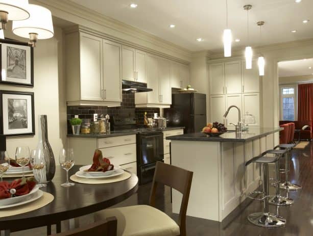 traditional open kitchen with antique white recessed style cabinets and black appliances