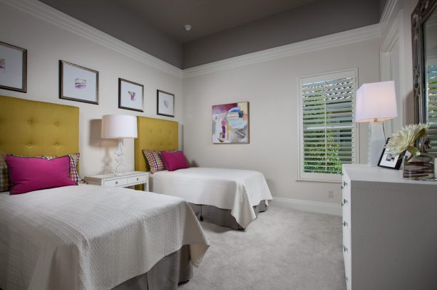 grey and yellow bedroom with pink pillows