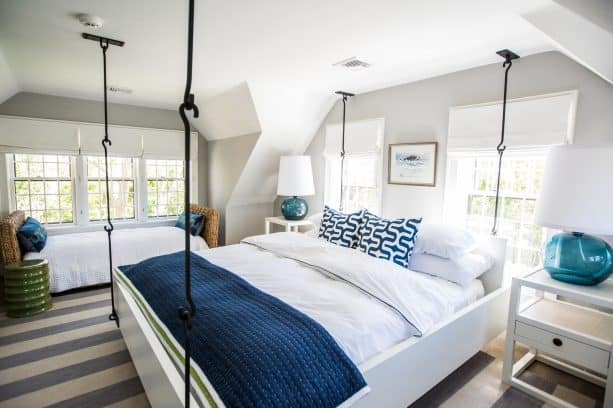 light grey bedroom with navy pillows and blanket