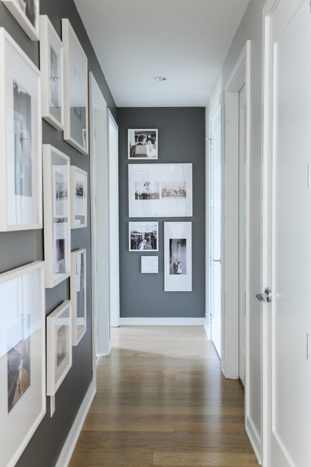 a hallway with dark grey paint and white trim