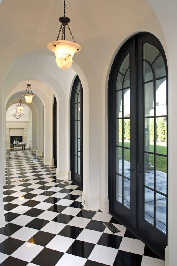 white hallway with black French doors