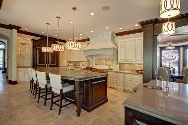 off-white cabinets paired with French style range hood with crown molding