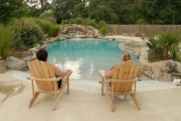 a small inground pool with beach entry