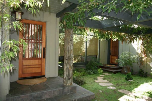 Asian-style entry with three rolled-up bamboo blinds