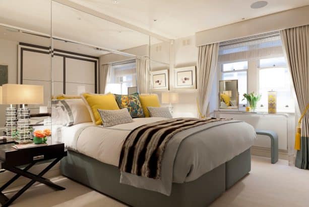 curtains, a contemporary acrylic table, and a bench to decorate a short wide bedroom window
